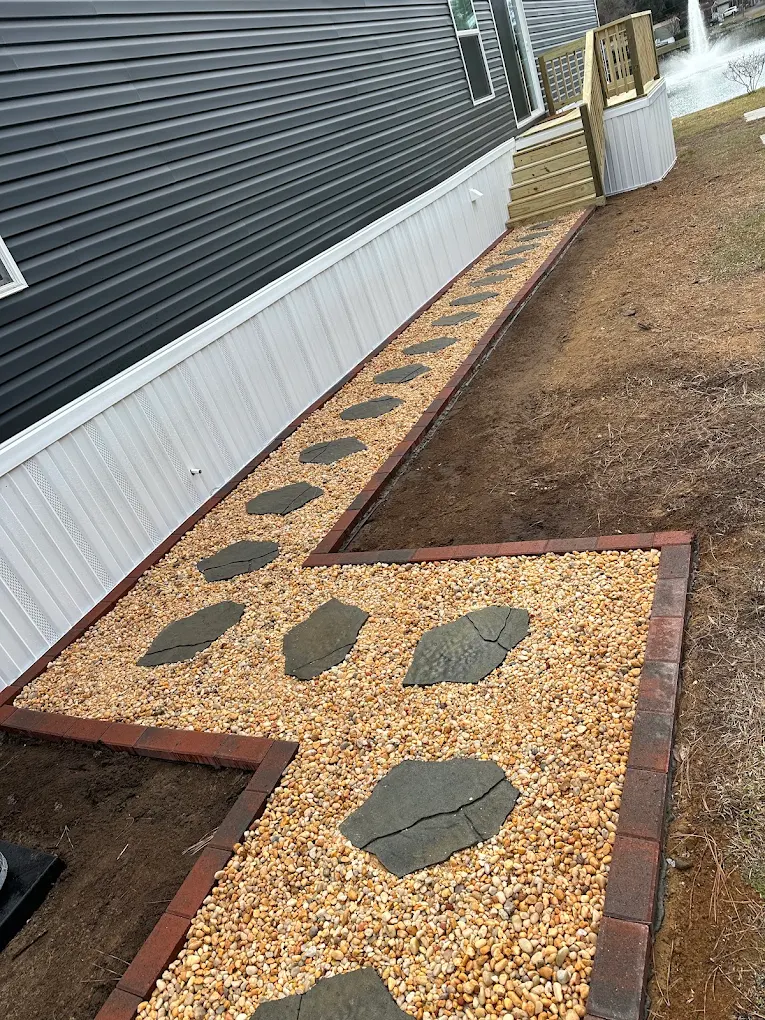 Pea gravel walkway with large stepping stones and brick border