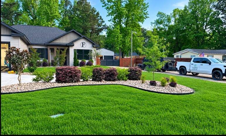 Curved landscape bed with fresh mulch and shrubs along the front lawn of a Grand Strand home