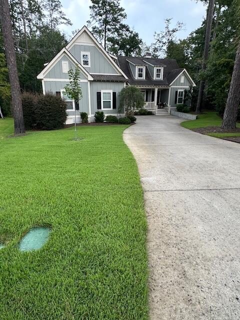 Well-maintained lawn in front of a two-story coastal home