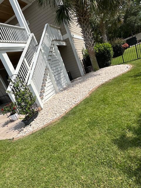 Trimmed palms and shrubs along a rock walkway